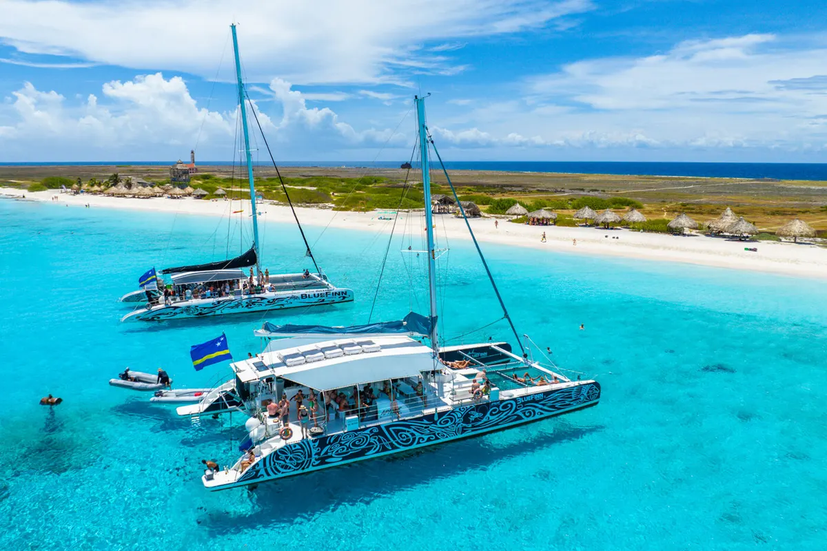 BlueFinn catamarans anchored off the beach at Klein Curaçao