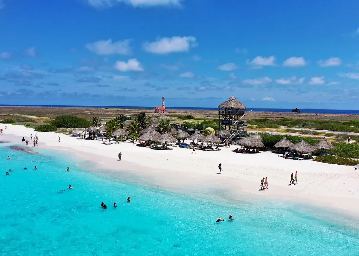 Beach, palapas, and the lighthouse on Klein Curaçao